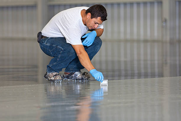 man is applying epoxy coating for a floor in Litchfield County, CT