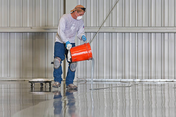 epoxy contractor is pouring a bucket of high gloss epoxy finish in Litchfield County, CT
