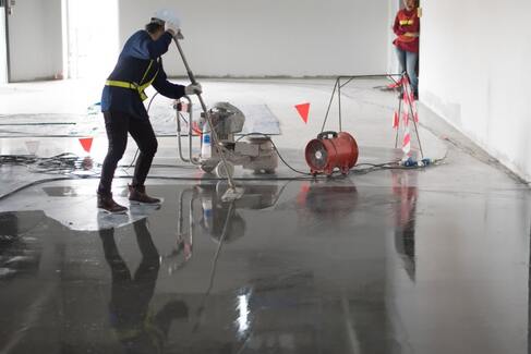 men working to install epoxy flooring for a car showoom in Morris, CT